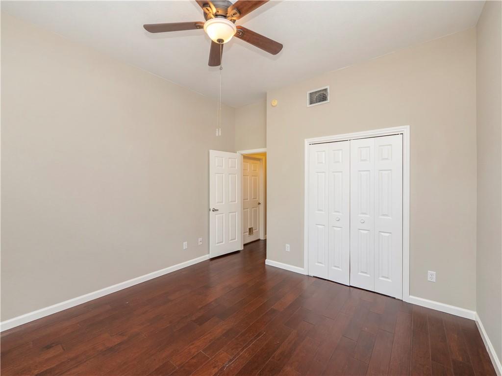 2206 Boneset Trail Round Rock, TX 78665 - Photo 26 of 35 an empty room with wooden floor closet and ceiling fan