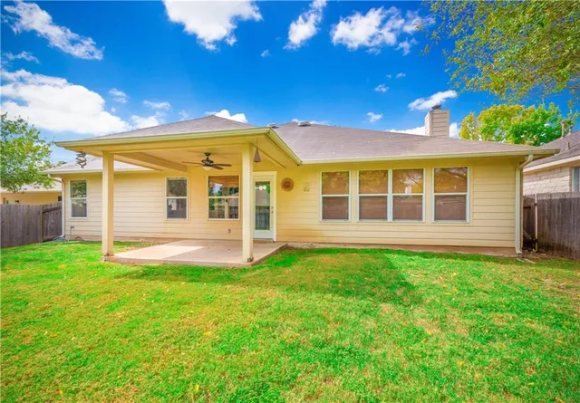 a view of a house with a backyard