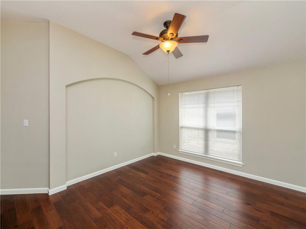 2206 Boneset Trail Round Rock, TX 78665 - Photo 8 of 35 an empty room with wooden floor fan and windows