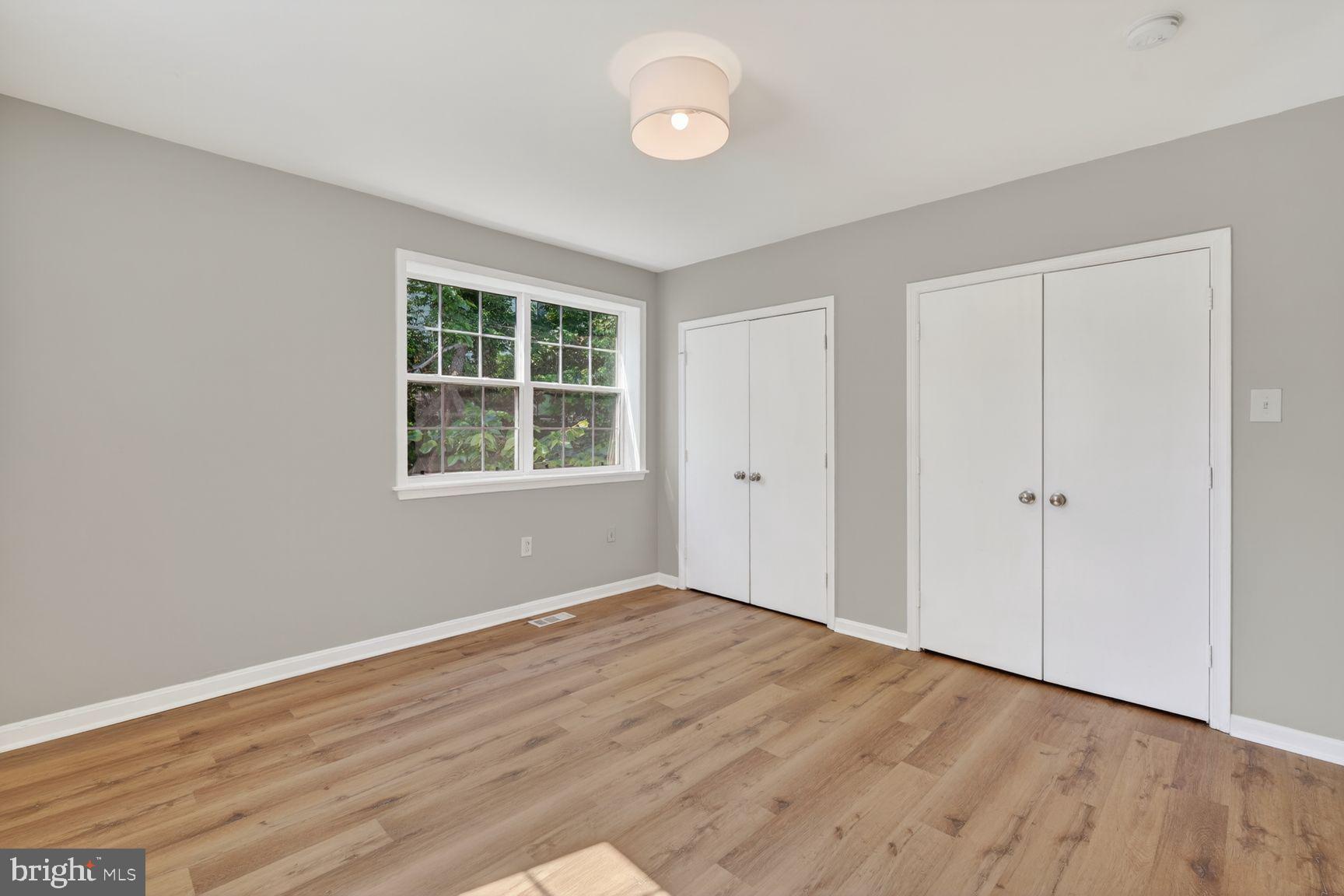 1008 Rittenhouse Street Northwest, Unit 15 Washington, DC 20011 - Photo 30 of 39 an empty room with wooden floor and windows