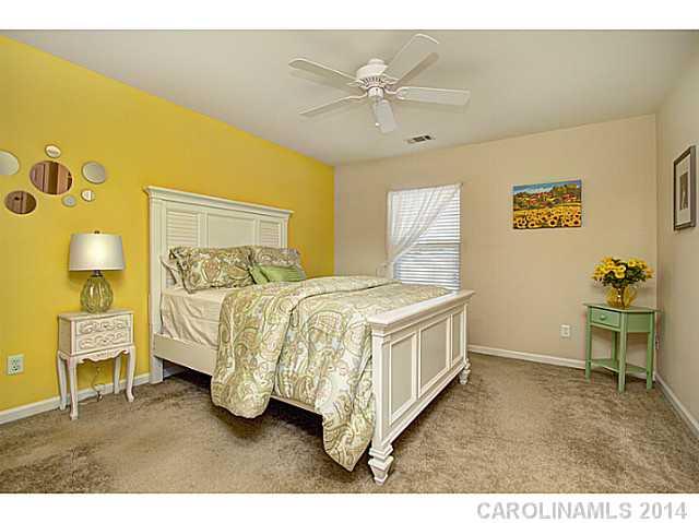 146 Council House Road, Unit 168 Fort Mill, SC 29708 - Photo 12 of 16 a spacious bedroom with a bed and a table in it