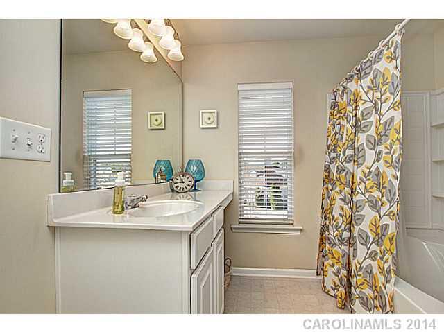146 Council House Road, Unit 168 Fort Mill, SC 29708 - Photo 13 of 16 a bathroom with a sink vanity granite and a mirror