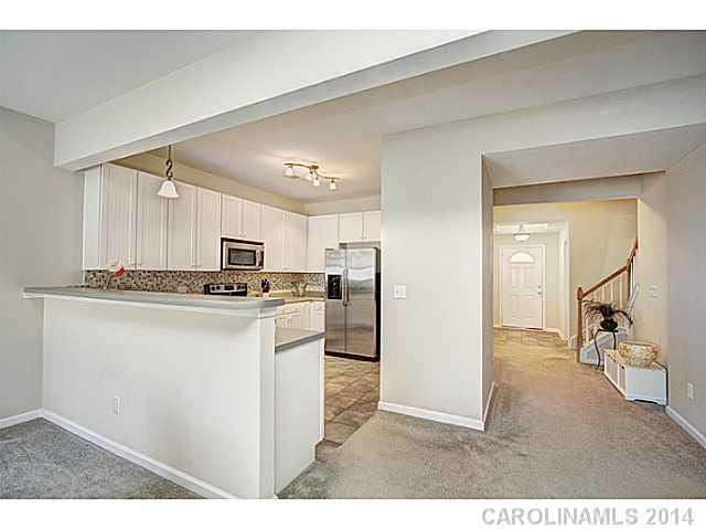 146 Council House Road, Unit 168 Fort Mill, SC 29708 - Photo 7 of 16 a kitchen with kitchen island a sink stainless steel appliances and cabinets