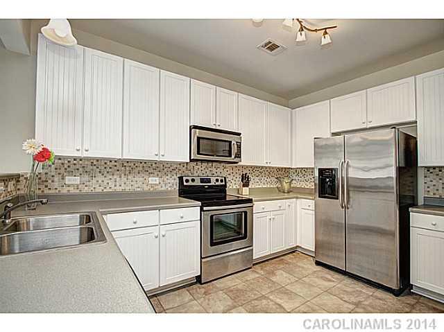 146 Council House Road, Unit 168 Fort Mill, SC 29708 - Photo 8 of 16 a kitchen with a sink stainless steel appliances and cabinets
