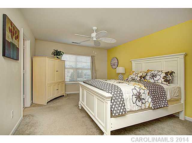 146 Council House Road, Unit 168 Fort Mill, SC 29708 - Photo 9 of 16 a bedroom with a bed and a chandelier