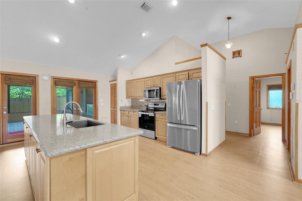 1207 Overlook Road Eustis, FL 32726 - Photo 11 of 44 a kitchen with refrigerator cabinets and wooden floor