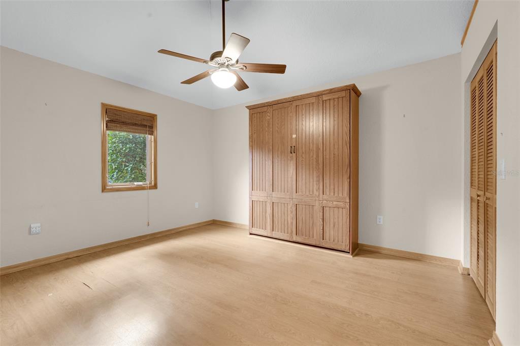 1207 Overlook Road Eustis, FL 32726 - Photo 25 of 44 an empty room with windows and fan