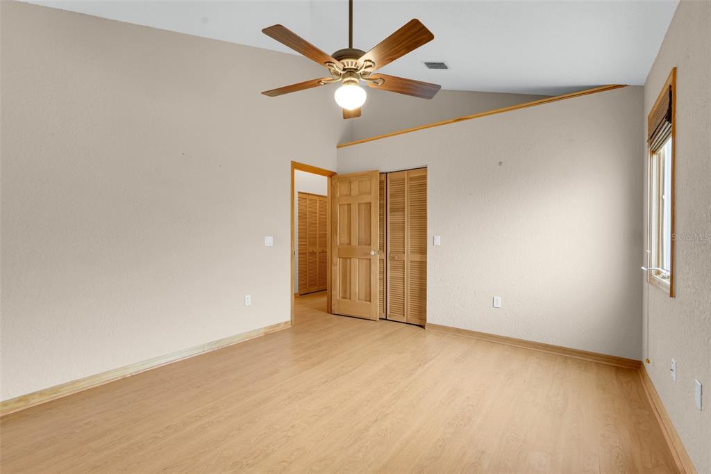 1207 Overlook Road Eustis, FL 32726 - Photo 26 of 44 an empty room with closet and a ceiling fan