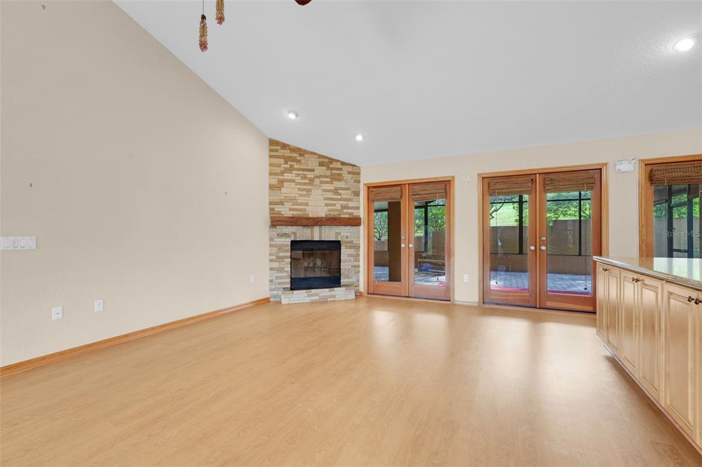 1207 Overlook Road Eustis, FL 32726 - Photo 6 of 44 an empty room with floor to ceiling window and fireplace