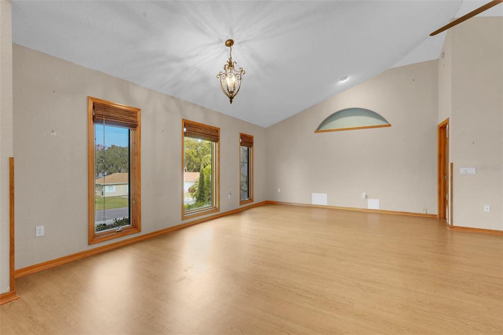 1207 Overlook Road Eustis, FL 32726 - Photo 8 of 44 wooden floor in an empty room with a window