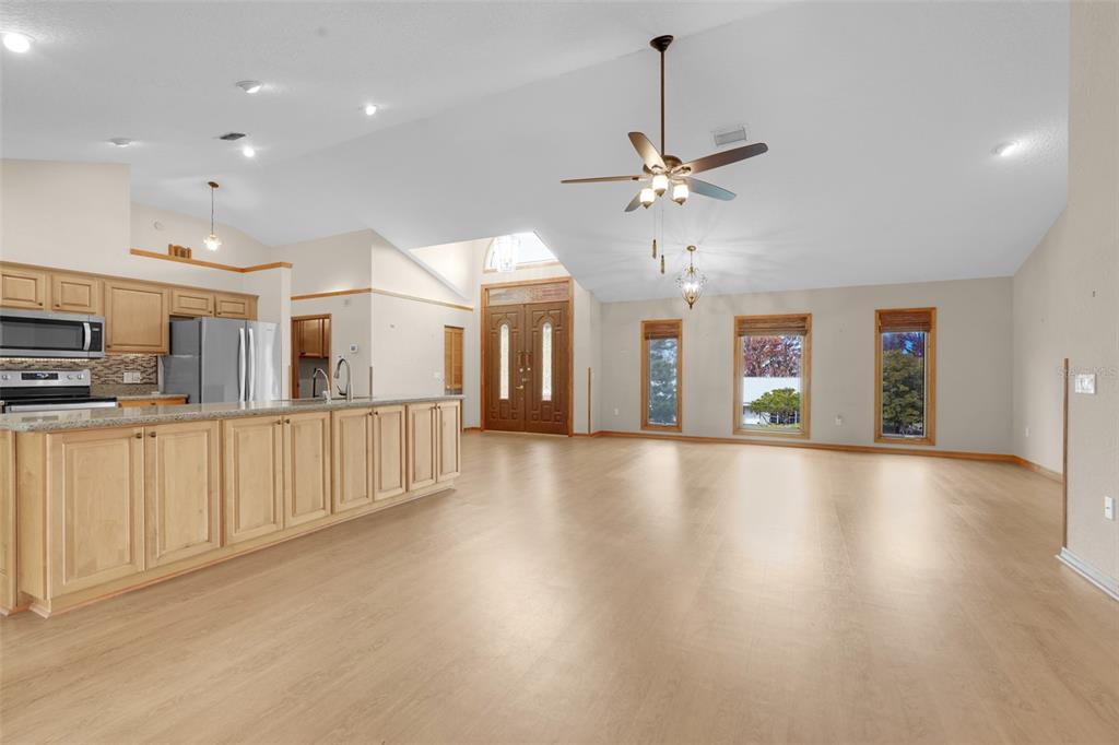 1207 Overlook Road Eustis, FL 32726 - Photo 9 of 44 a view of a kitchen with furniture and a ceiling fan