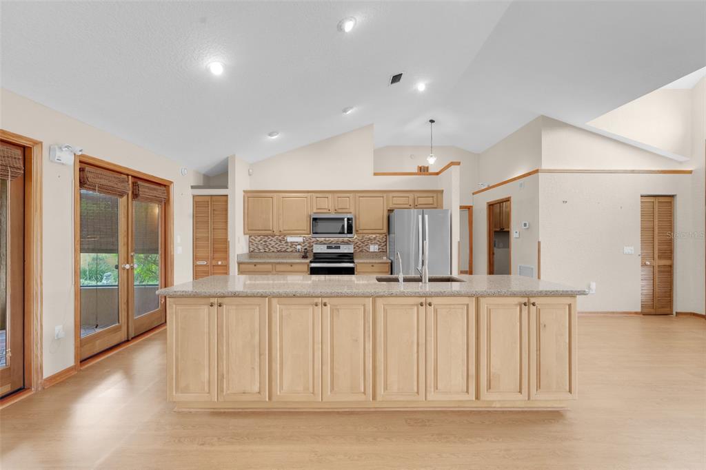 1207 Overlook Road Eustis, FL 32726 - Photo 10 of 44 a kitchen with stainless steel appliances granite countertop a refrigerator and a sink