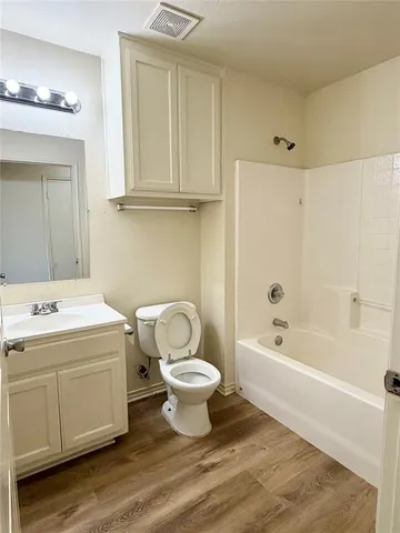a bathroom with a sink a toilet and bathtub