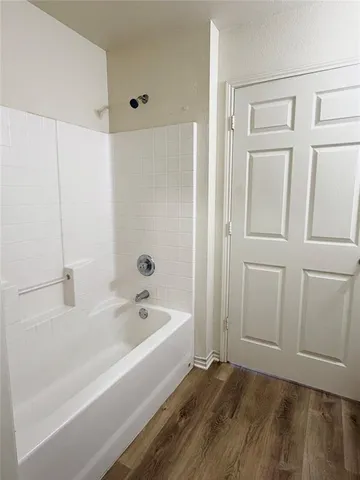 a bathroom with a bathtub and shower