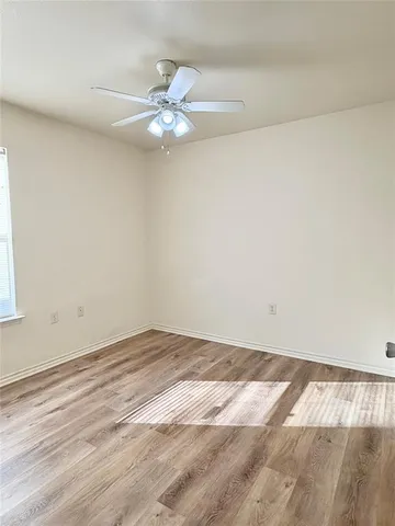 a view of a room that has a fan and a window