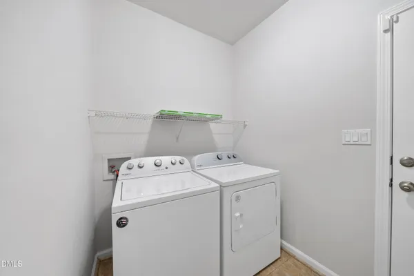 a view of kitchen with stainless steel appliances granite countertop a stove and a refrigerator