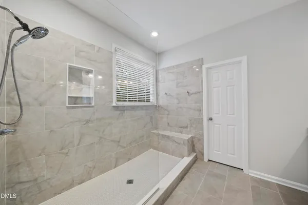 a kitchen with kitchen island granite countertop a sink a stove a microwave a counter top space and cabinets