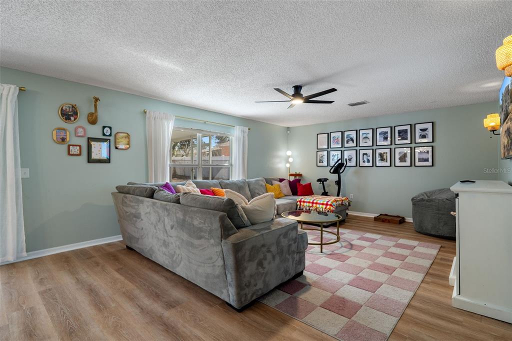 11258 Lomita Wren Road Weeki Wachee, FL 34614 - Photo 19 of 44 a living room with furniture and a window