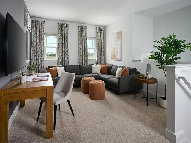 a living room with furniture a chandelier a window and a flat screen tv