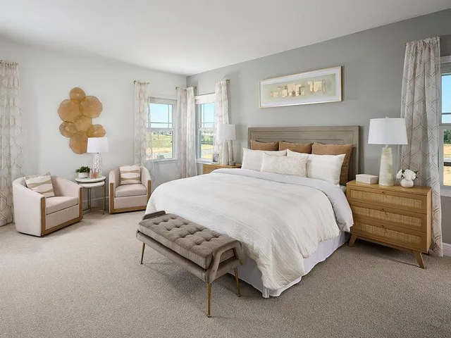 a spacious bedroom with a bed and a large window