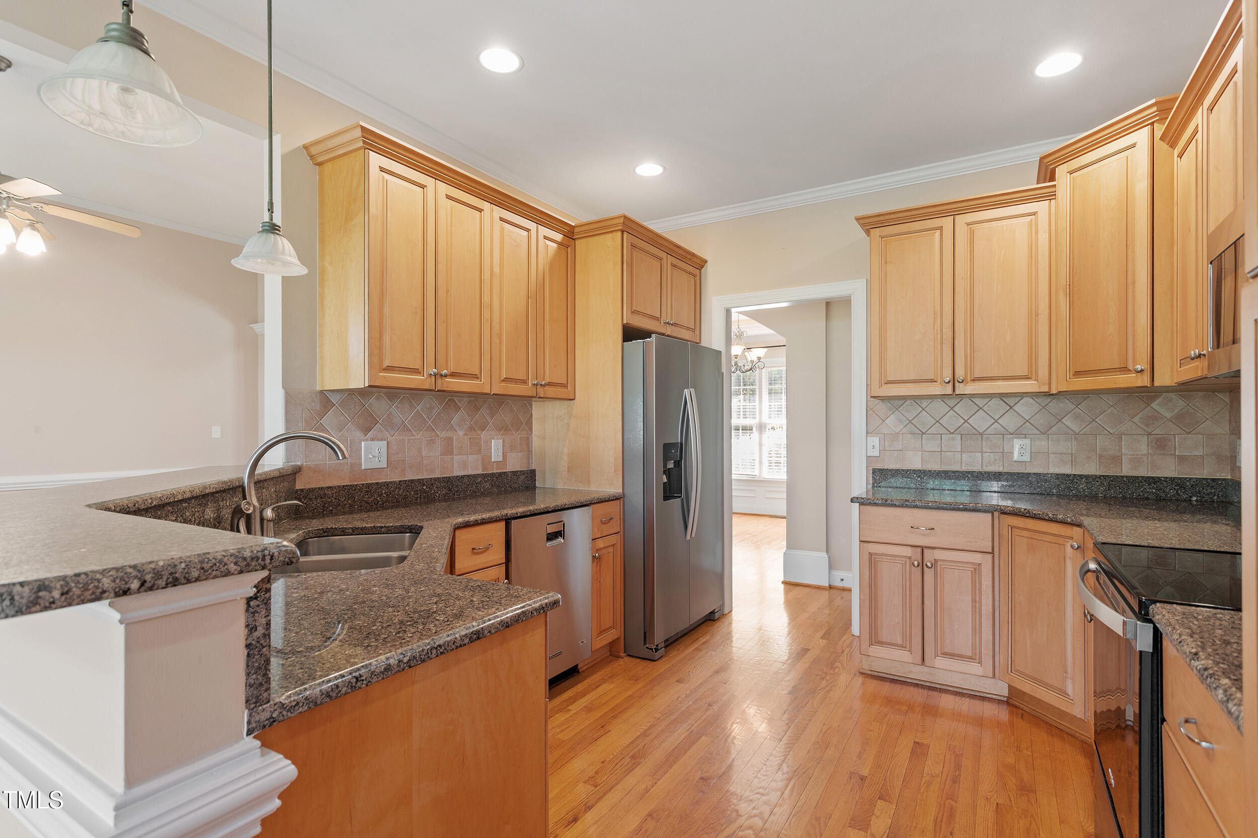 97 Rand Road Raleigh, NC 27603 - Photo 11 of 34 a kitchen with stainless steel appliances granite countertop a sink stove and refrigerator