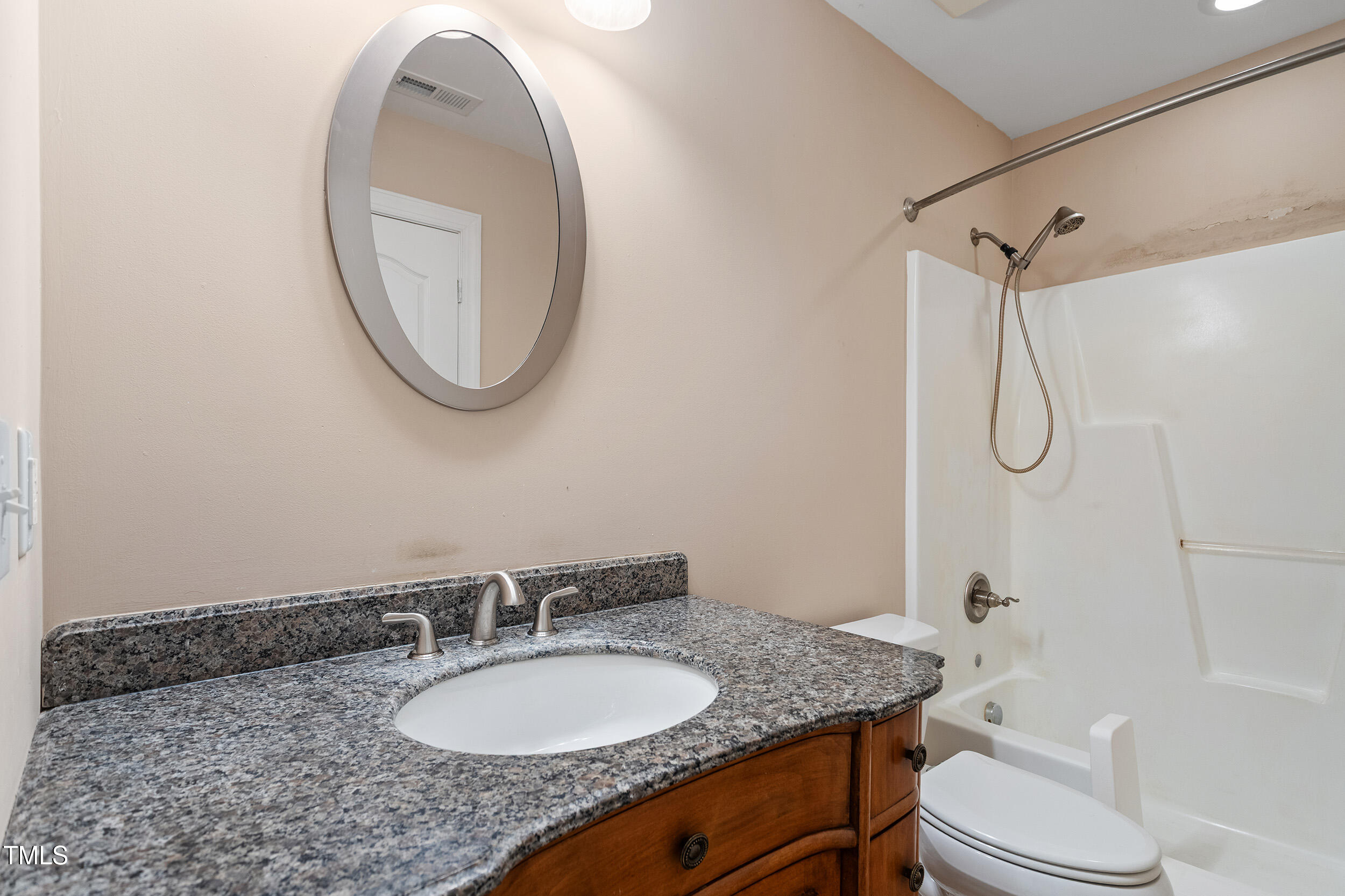 97 Rand Road Raleigh, NC 27603 - Photo 25 of 34 a bathroom with a granite countertop sink toilet a mirror and shower