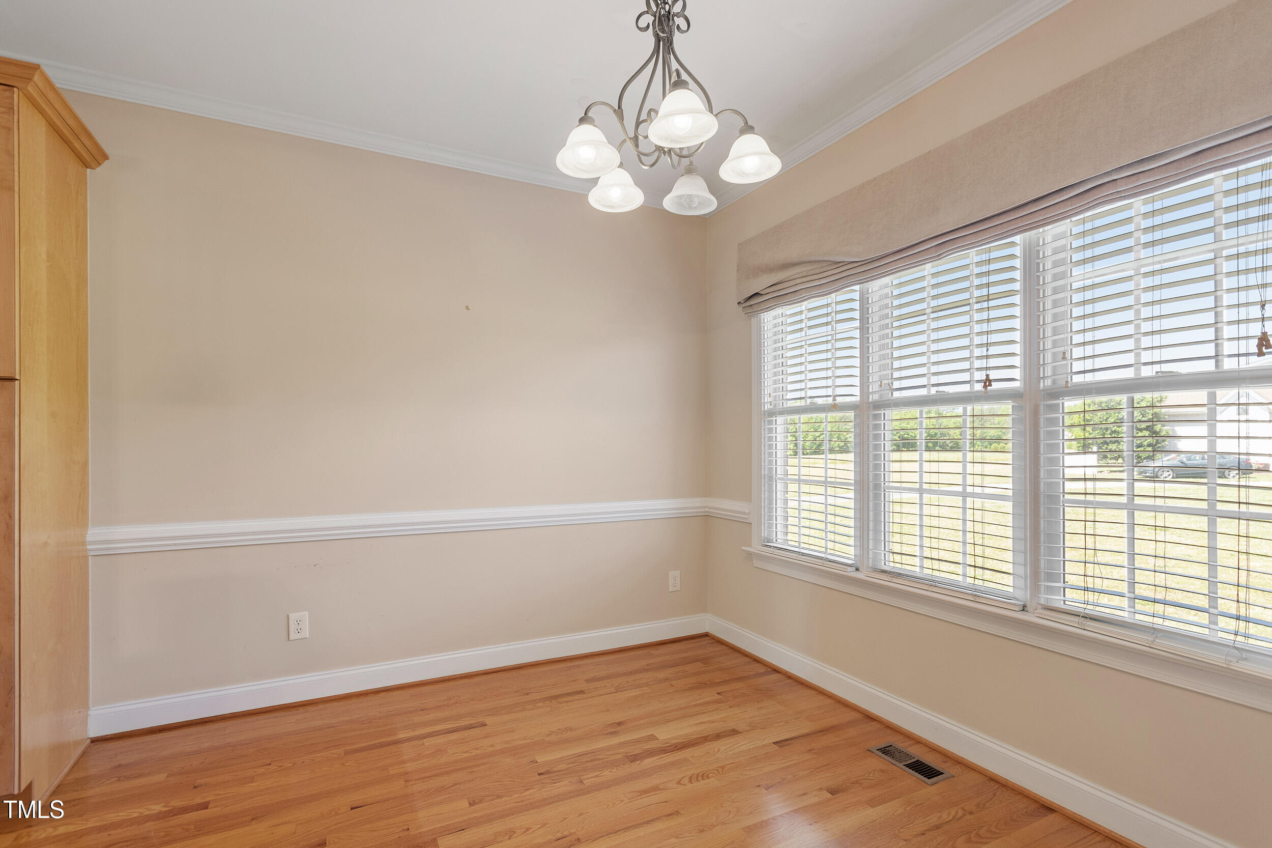 97 Rand Road Raleigh, NC 27603 - Photo 10 of 34 a view of an empty room with wooden floor and a window