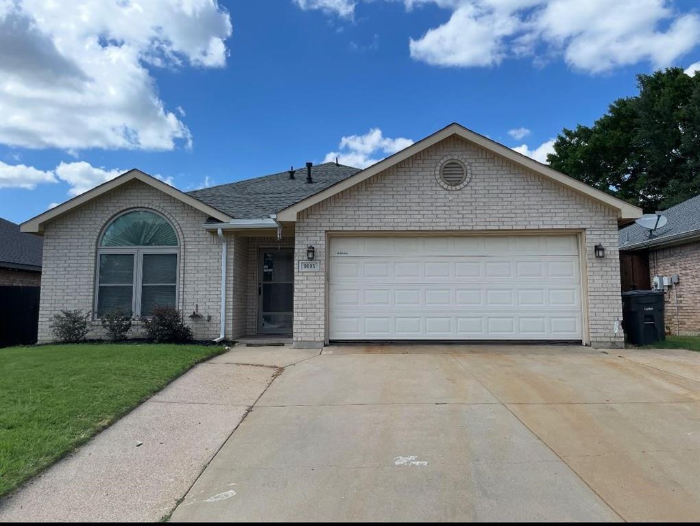 a view of a house with a yard and garage