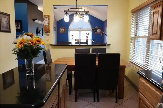 a kitchen with a table chairs and appliances