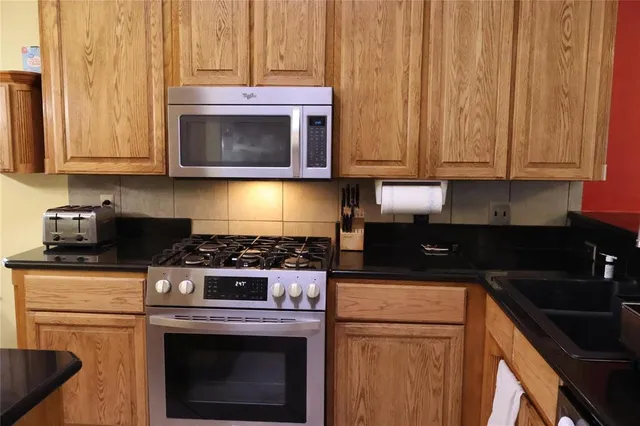 a kitchen with a stove and a microwave