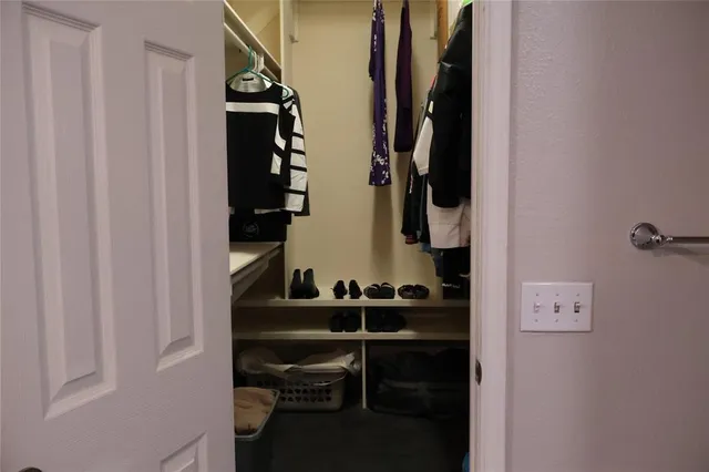 a view of closet with stairs