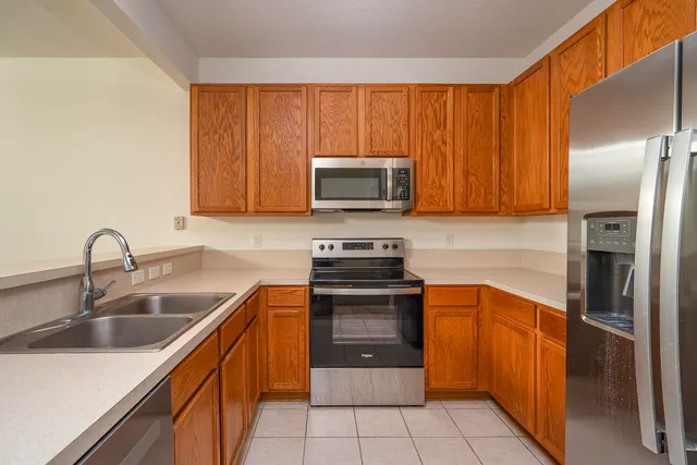 a bathroom with a sink and a washing machine in a bathroom