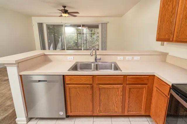 a patio with table and chairs and potted plants