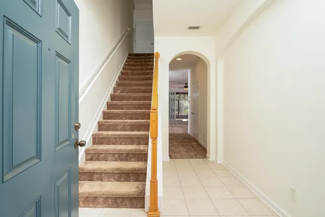 a white toilet sitting next to a shower
