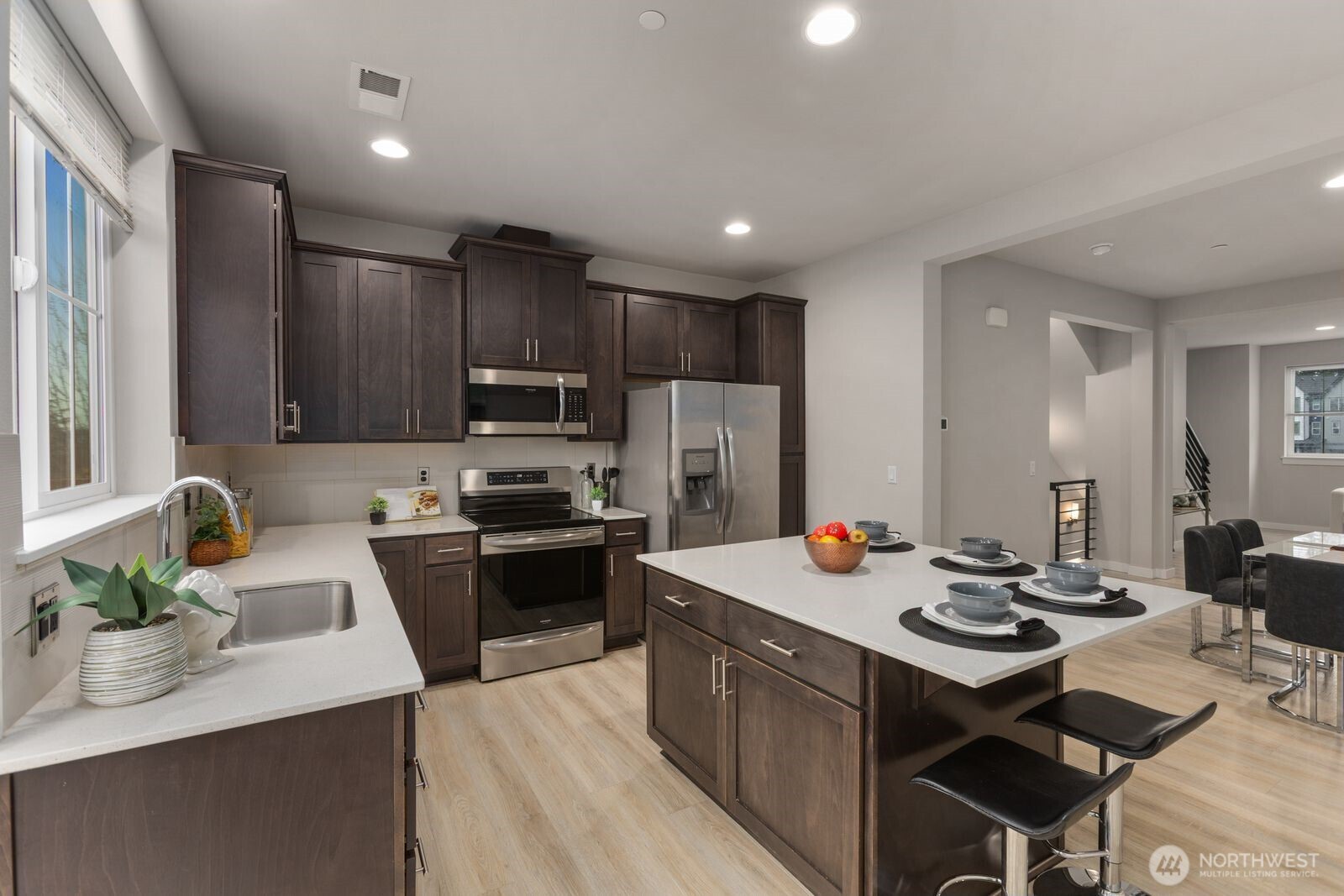 1621 Seattle Hill Road, Unit C4 Bothell, WA 98012 - Photo 13 of 35 a kitchen with kitchen island a stove a sink a refrigerator and chairs