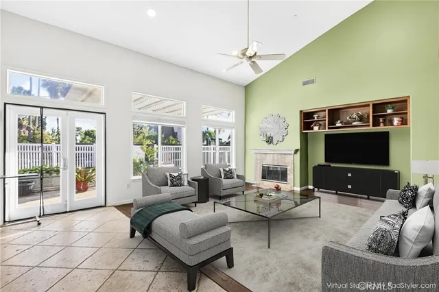 a living room with furniture a flat screen tv and a large window