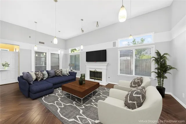 a living room with furniture a fireplace and a flat screen tv