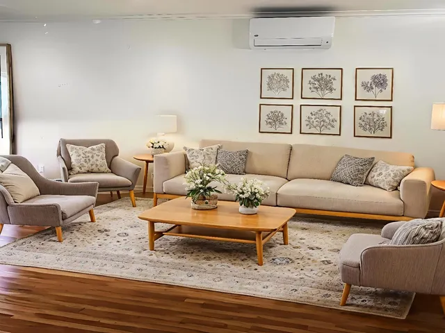 a living room with furniture and painting on the wall