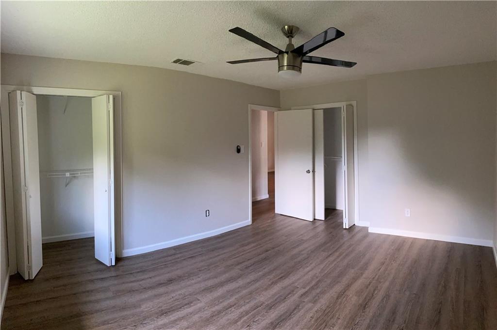 1715 Shadowview Drive, Unit B Austin, TX 78758 - Photo 25 of 28 A spacious room offers new laminate flooring, a modern ceiling fan, and ample closet storage.