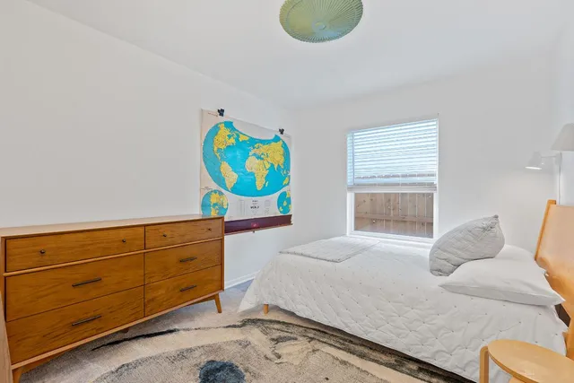 a bedroom with a bed and window