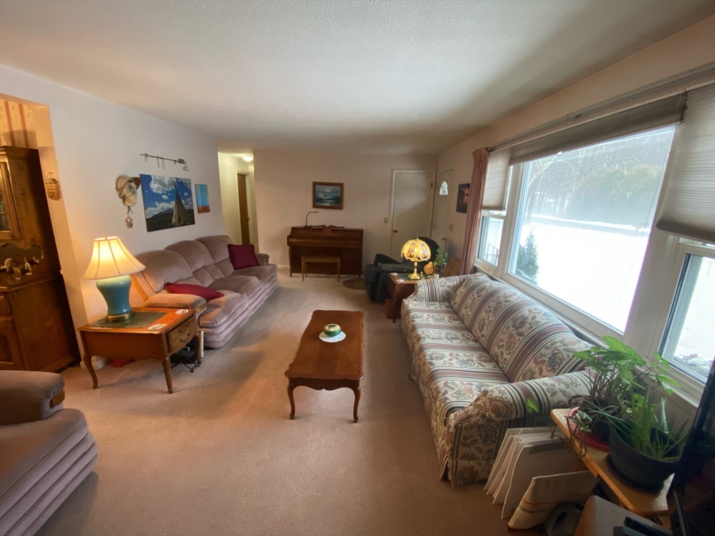 155 Ponakin Road Lancaster, MA 01523 - Photo 7 of 19 a living room with furniture and a flat screen tv