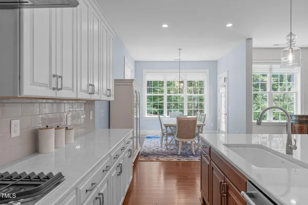 a kitchen with granite countertop a sink and a stove top oven