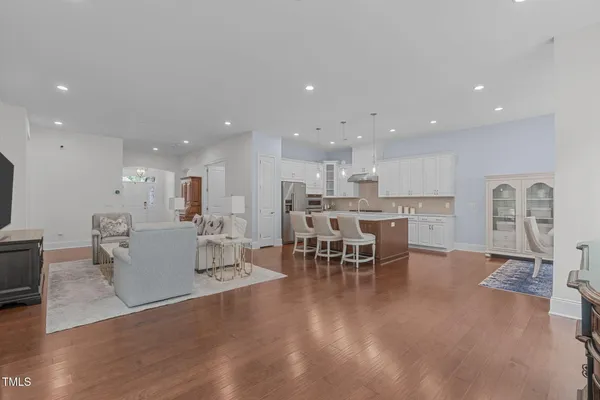 a large kitchen with cabinets table and chairs