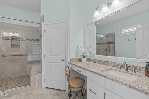 a bathroom with a glass shower door