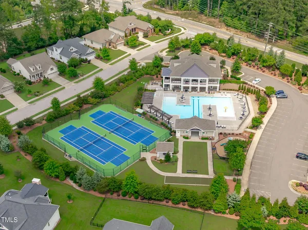 an aerial view of a house with a garden and parking
