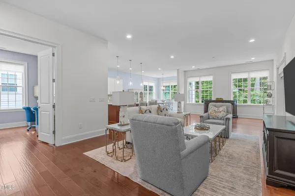 a living room with furniture and a wooden floor