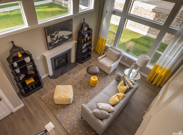 9294 South Rose Cottage Way, Unit 207 Sandy, UT 84094 - Photo 2 of 10 Living room featuring a tile fireplace and wood finished floors