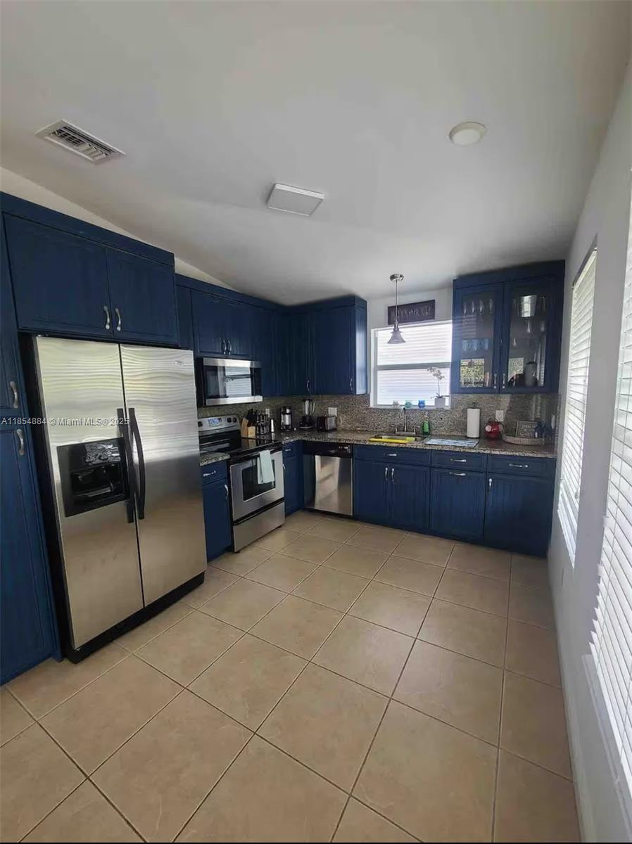 350 Hazel Street Key Largo, FL 33037 - Photo 3 of 22 a kitchen with stainless steel appliances granite countertop a refrigerator and a stove top oven