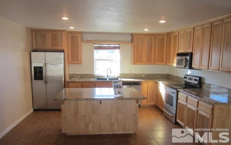 15815 Easy Street Reno, NV 89521 - Photo 5 of 13 a kitchen with kitchen island granite countertop a sink cabinets and stainless steel appliances