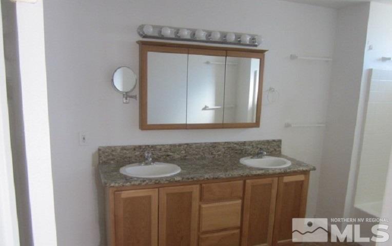 15815 Easy Street Reno, NV 89521 - Photo 8 of 13 a bathroom with a granite countertop sink and a mirror